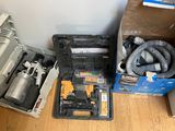 a box of tools sitting on the floor next to a box of other items