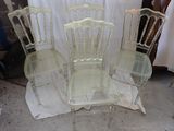four chairs sitting next to each other in a room