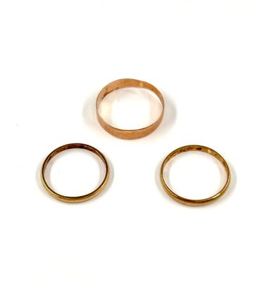 three different types of wedding rings on a white surface