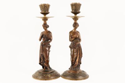 pair of antique bronze candlesticks with female figures on them