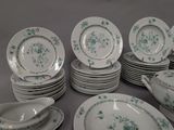 a lot of plates and bowls on the table