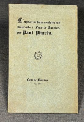 an old book sitting on top of a table on a gray surface