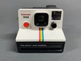 a close up of a polaroid land camera on a table
