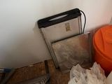 a orange bucket sitting on top of a table next to a trash can