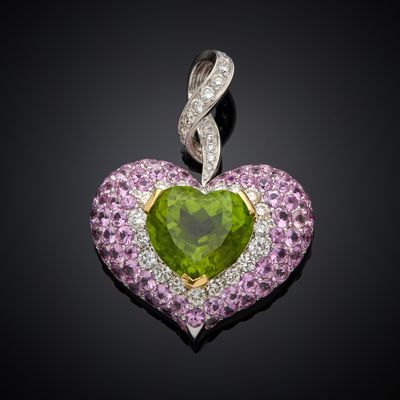 a close up of a green heart shaped pendant with pink and white diamonds