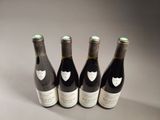 three bottles of wine are lined up on a table