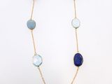 a necklace with blue and white stones on a gold chain