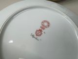 a white plate with a red design on it