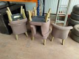 four chairs and a table in a room