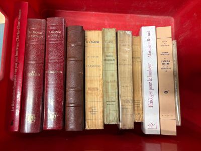 many books in a red box on a table