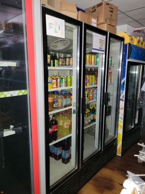several refrigerators that are lined up in a store
