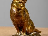 statue of a cat sitting on a rock on a table