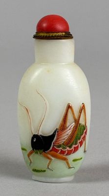 a small glass bottle with a painting of a bug on it