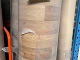 many rolls of wood in a store with a price tag on it