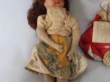 two dolls that are sitting next to each other on a table