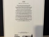 the back of a white box with a green sticker on the side of it