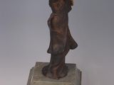 statue of a woman holding a bird on a marble base