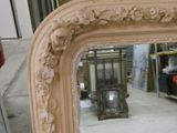 a mirror that is sitting on the floor in a room