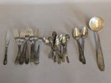 a lot of spoons, forks and spoons on the table