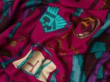the fabric is multicolored and has a pattern of horses on it