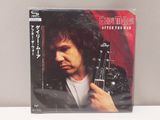 a cd with a picture of a man holding a guitar