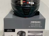 a black helmet on top of a box on the floor