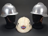 pair of white hard hats sitting next to each other on a mannequin head
