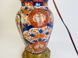 a large vase with a handle on a table