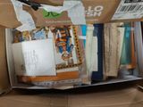 a box full of books and a pair of scissors in it