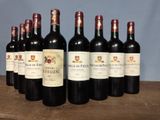 six bottles of wine are lined up on a wooden table