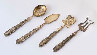 four pieces of silverware including a fork, spoon, and knife