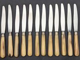six knives are lined up in a row on a table