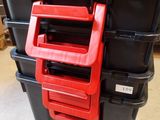 a stack of black and red storage boxes with red handles