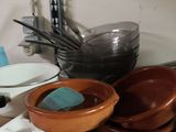 many bowls and pans sitting on the counter