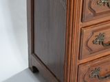 a small wooden chest of drawers with a drawer on top