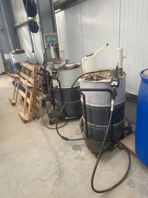 several barrels of water sitting next to each other in a warehouse