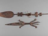 three old metal objects are displayed on a white surface