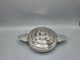 an antique silverplated casserole dish with a domed lid