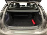 the back of a car with its trunk open and luggage in the trunk