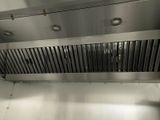 an image of a commercial kitchen with a stainless steel exhaust hood