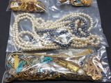 a bag of assorted jewelry on a black table