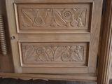 a close up of a wooden cabinet with carvings on it