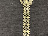 gold cross on a black cloth with a gold cross on it