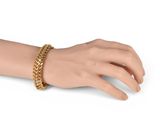 an image of a woman ' s hand with a gold chain bracelet