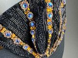 a close up of a bra top with beads on it