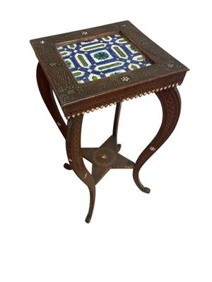 a small table with a blue and green tile top