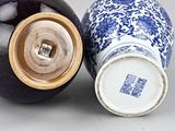 two blue and white vases sitting next to each other on a table