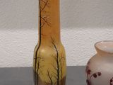 two vases sitting next to each other on a table