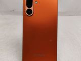 a close up of the back of an orange samsung galaxy s20