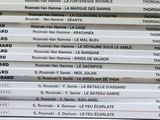a lot of books that are stacked on top of each other
